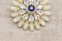 Elegant Crystal Bloom Brooch with Sapphire Center